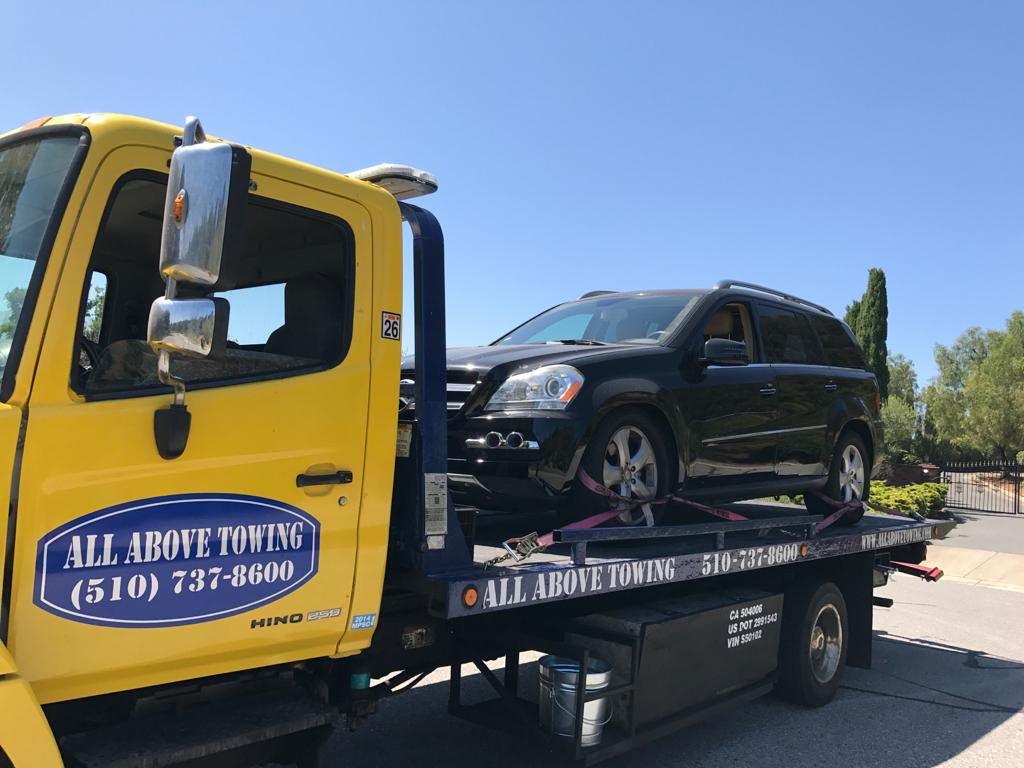 Image of Towing Truck with a yellow car1,All Above Towing LLC ,Tow truck Company